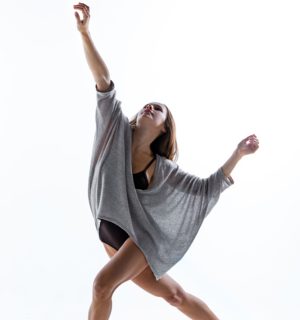 young-beautiful-dancer-beige-dress-dancing-white-wall